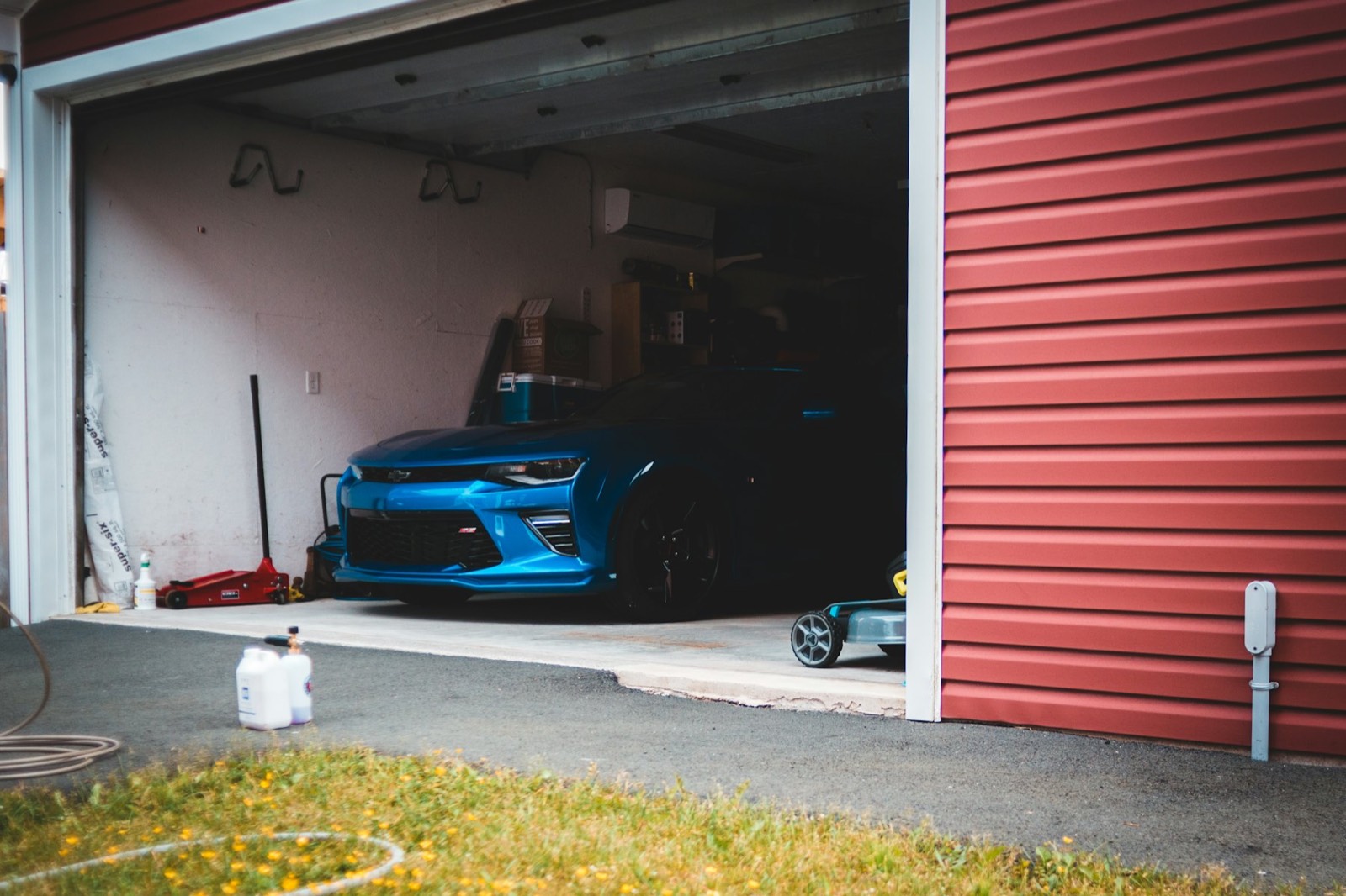 An open garage door with a car inside