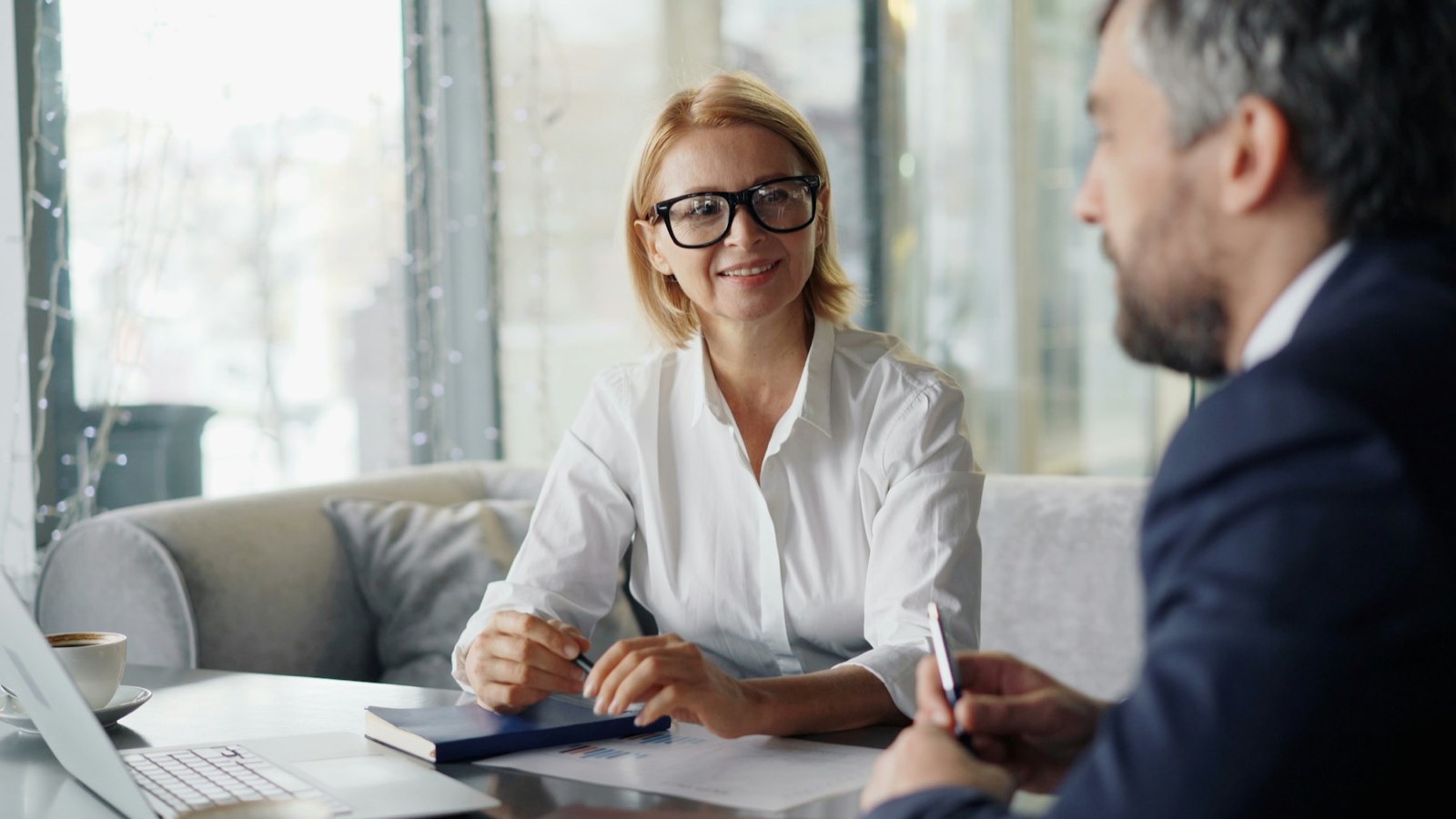A lawyer smiling during a client meeting