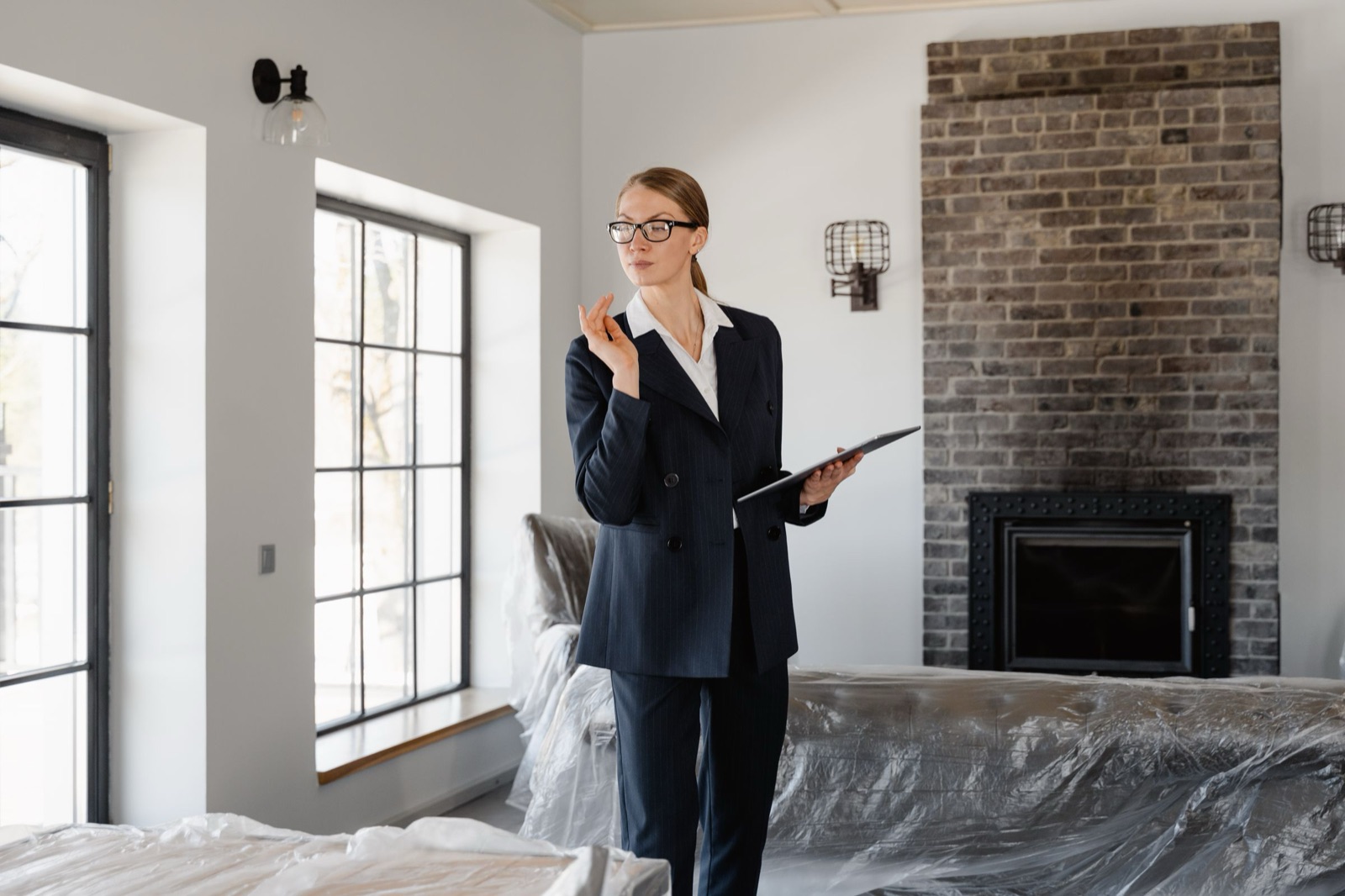 A property manager with a clipboard checking a furnished apartment