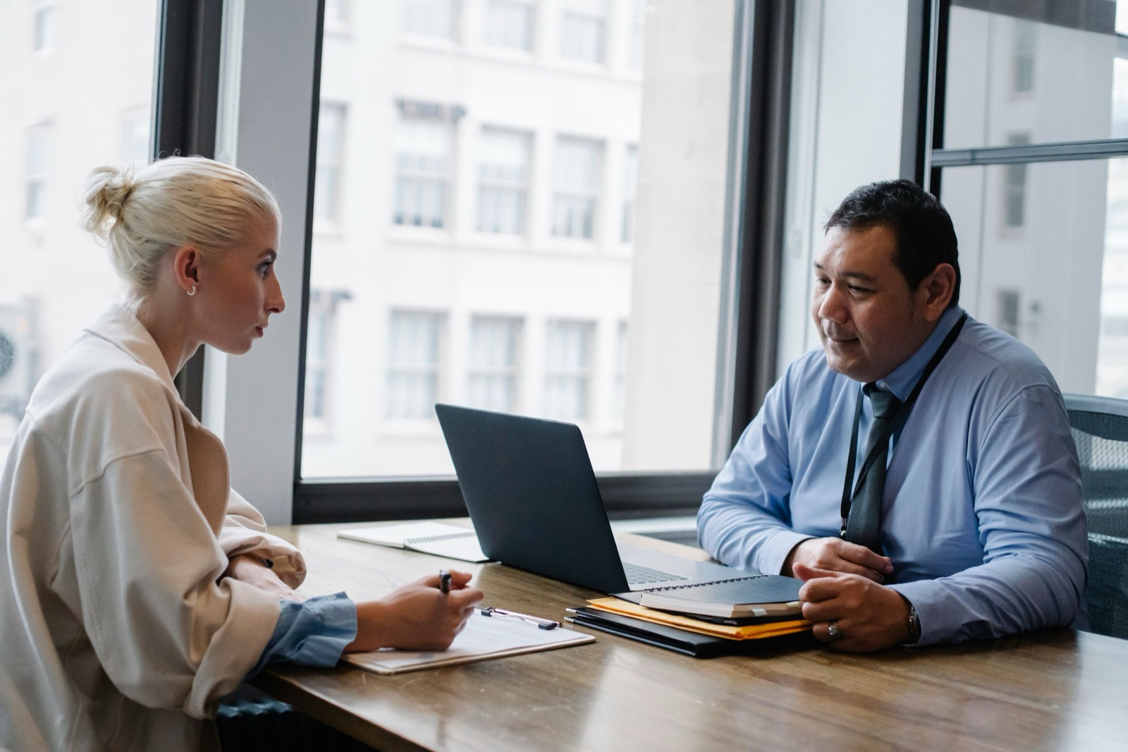 A recruiter interviewing a candidate at an office table